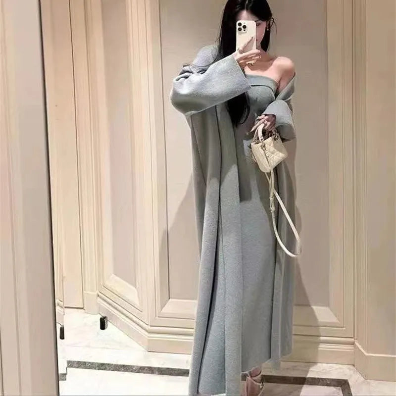 Women's grey knitted cardigan dress suit set with long skirt and flocking detail.