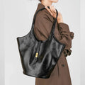 Black genuine leather bucket bag with sewing thread detail and single shoulder strap