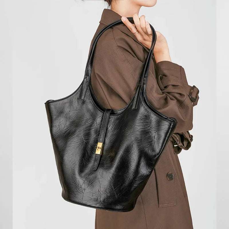 Black genuine leather bucket bag with sewing thread detail and single shoulder strap
