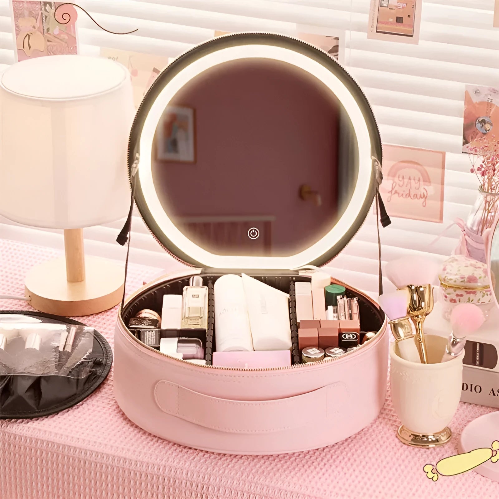 Round pink LED makeup bag open showing internal partitions and illuminated mirror.