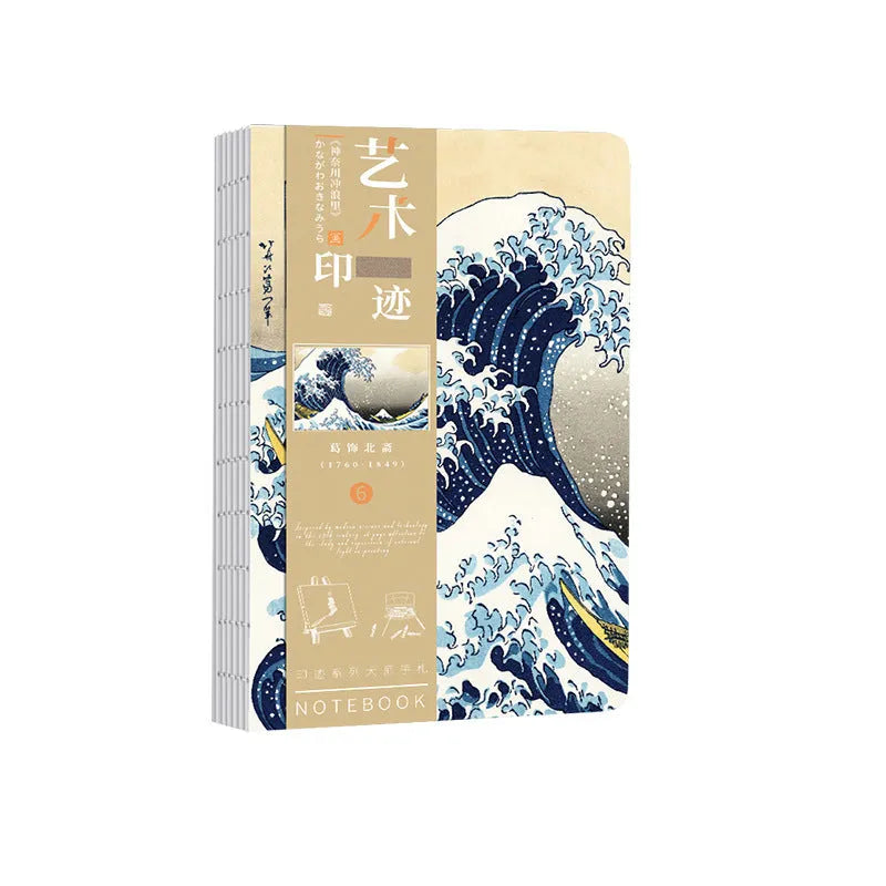 Ukiyo-e art hand ledger notebook open on a desk showing detailed Kanagawa wave cover and lined pages.