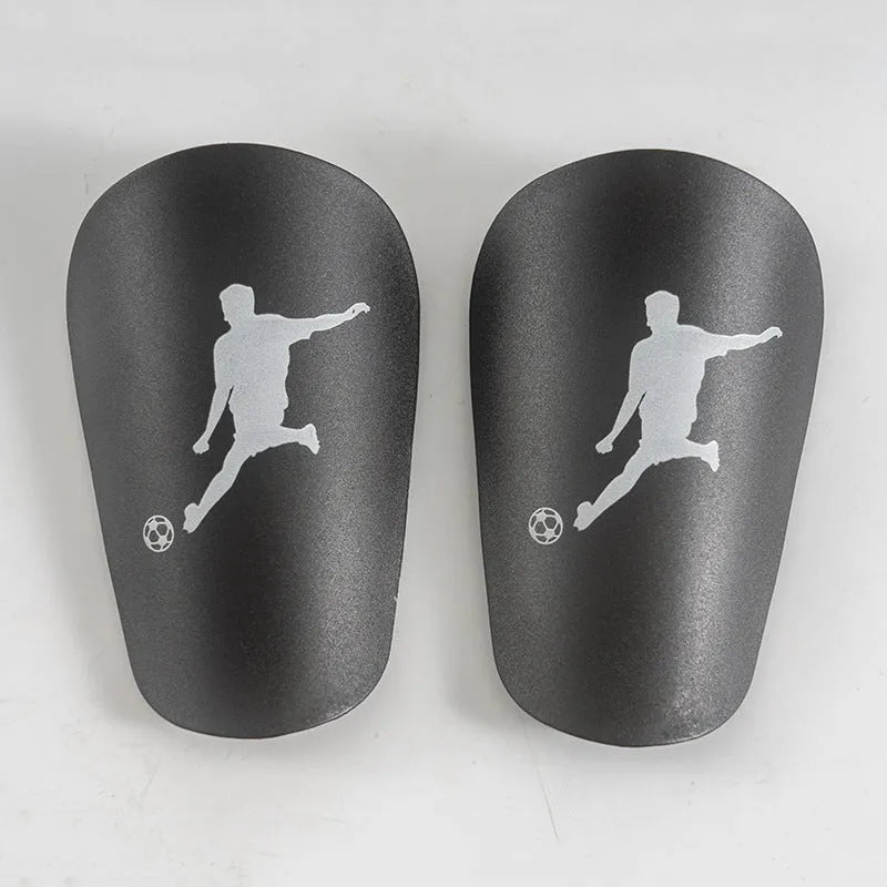 Mini football leg protector in black PU material, size XS, measuring 8 cm by 5 cm