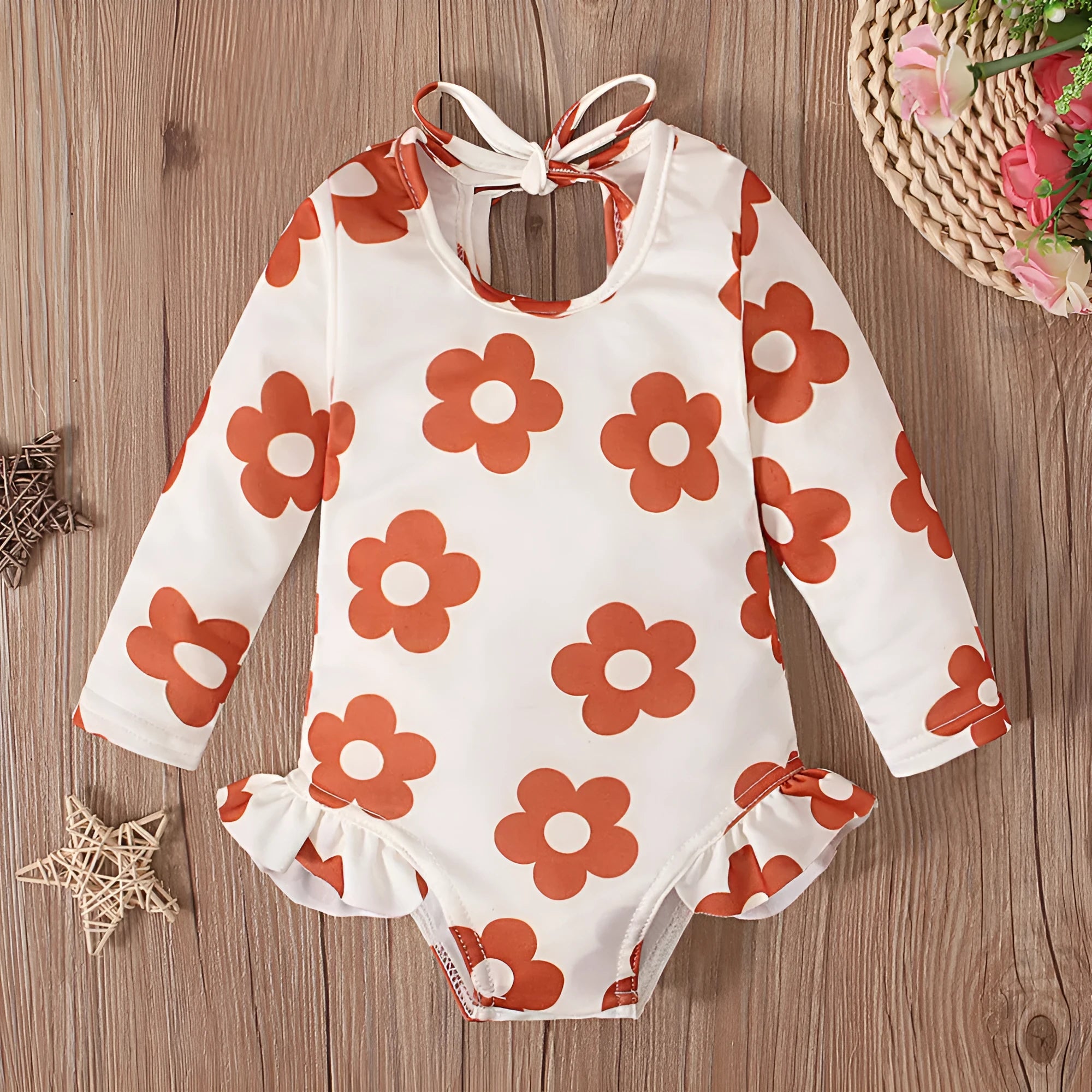 Girl's floral print swimsuit with crew neckline and open back design in orange colour