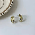 Gold and silver colour matching C-shaped brushed ring earrings with 925 silver needle on display