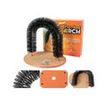 White plastic cat grooming arch scratcher toy with built-in brush bristles on a wooden floor.
