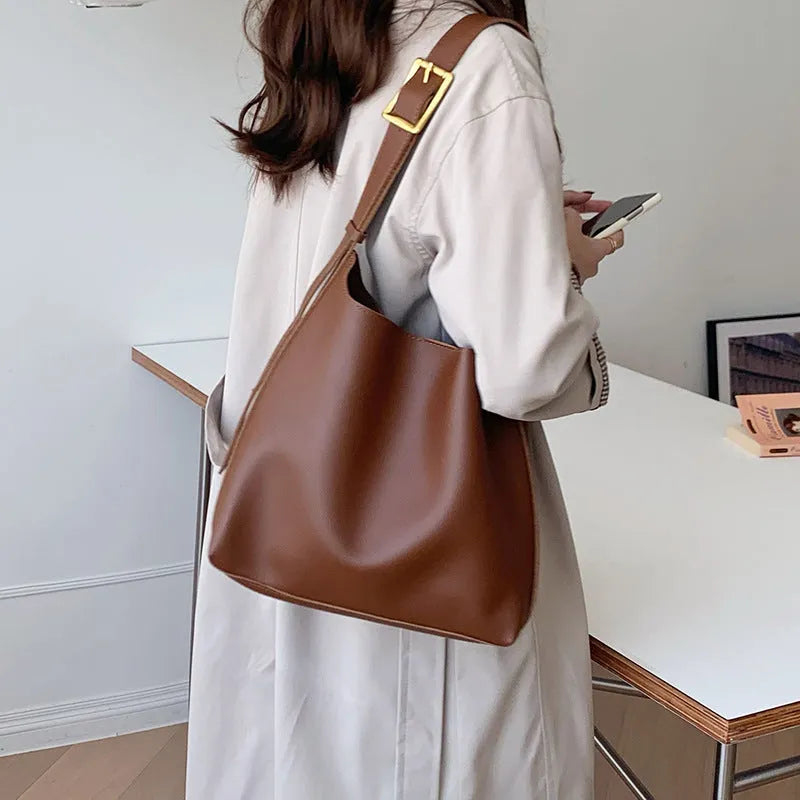 Women's solid colour PU leather shoulder bag in black, square vertical shape with sewing thread detail and single strap