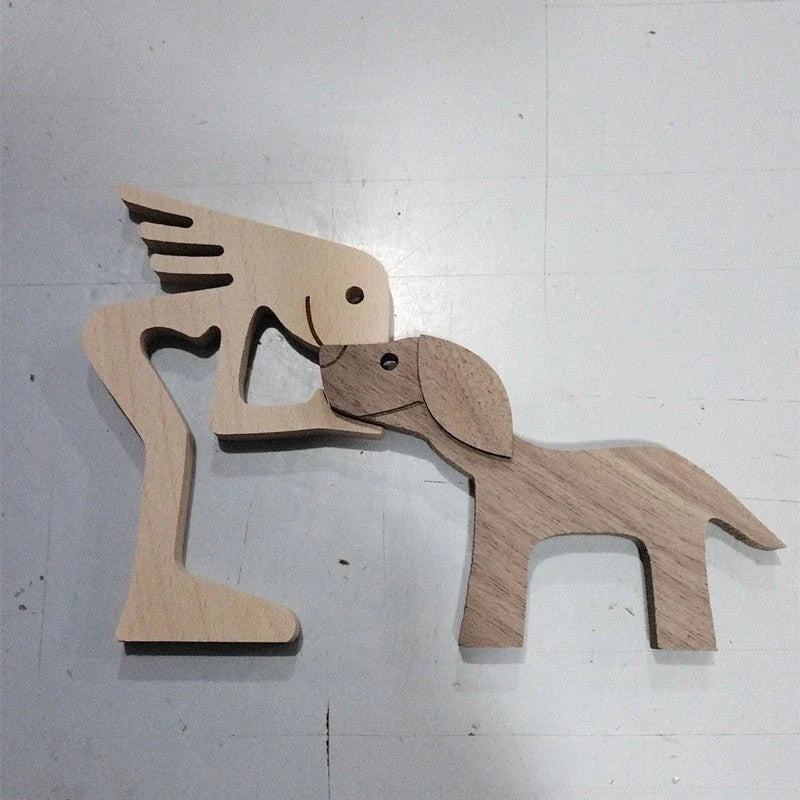 Handcrafted wooden dog sculpture featuring a man and his loyal canine companion