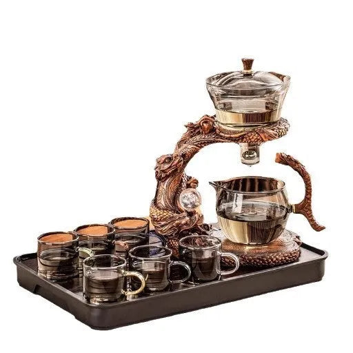 Green gray walnut glass automatic tea set with bowl, base, and fair cup on a table