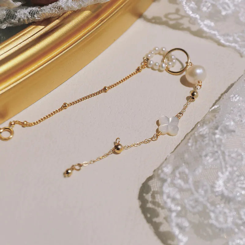 Women's natural pearl bracelet with gold-plated metal setting.