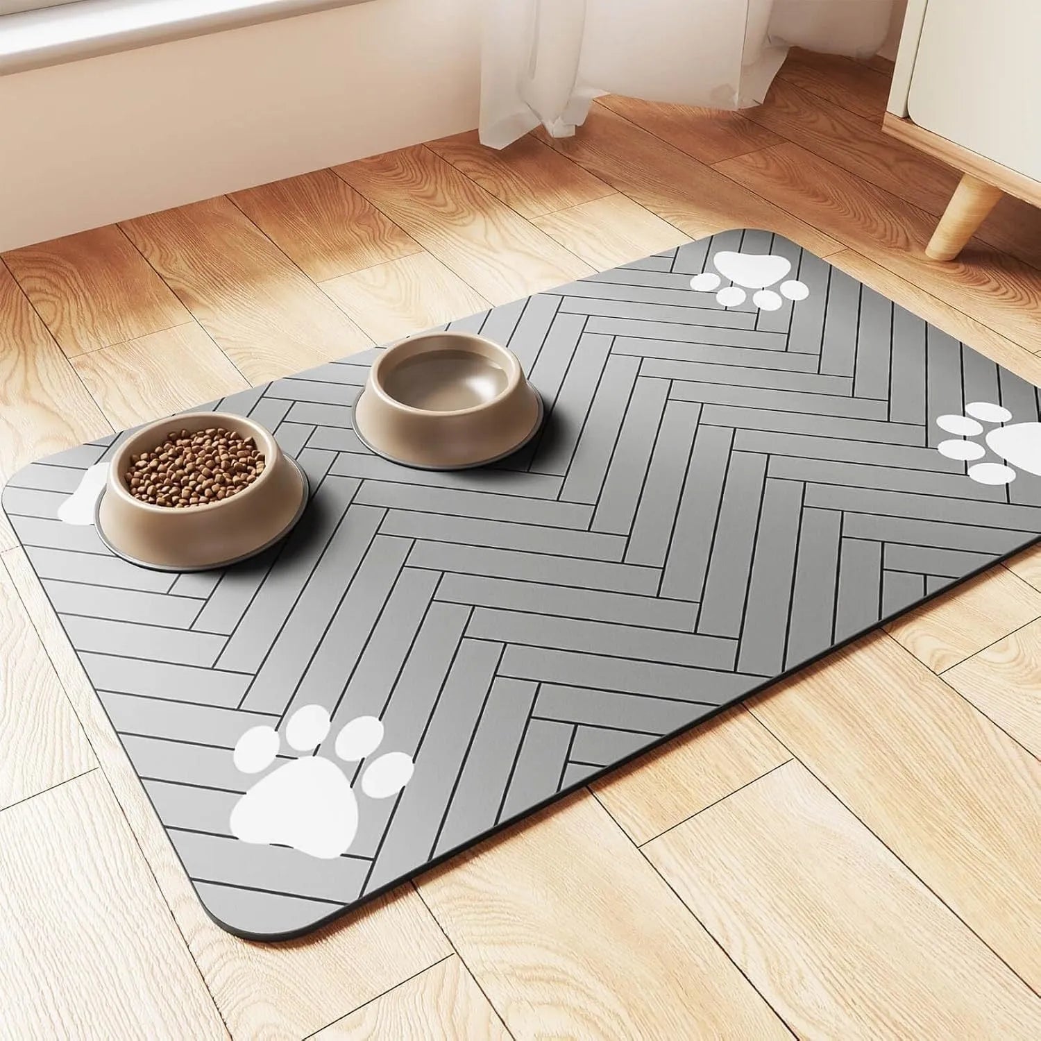 Blue diatomite absorbent mat for pet food and water bowls on a wooden floor.