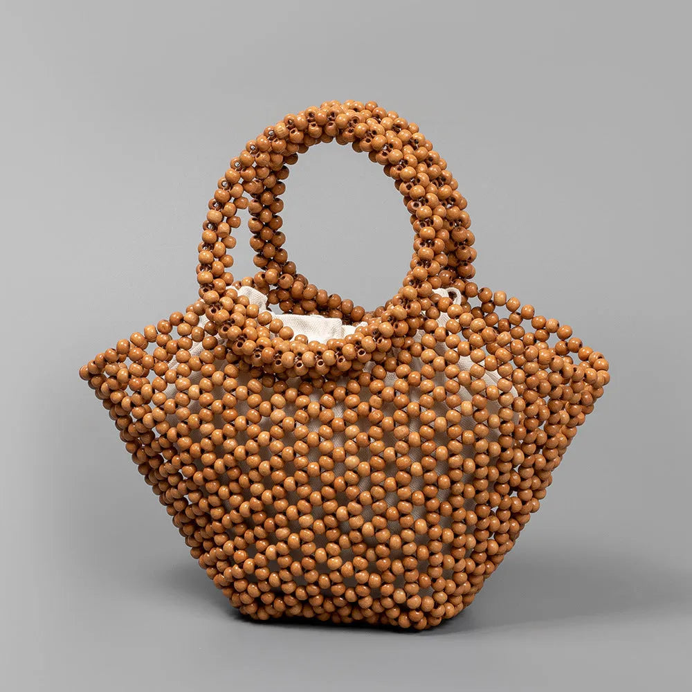 Maple wood woven dumpling-shaped handbag with wooden bead decoration, shown in milky white.