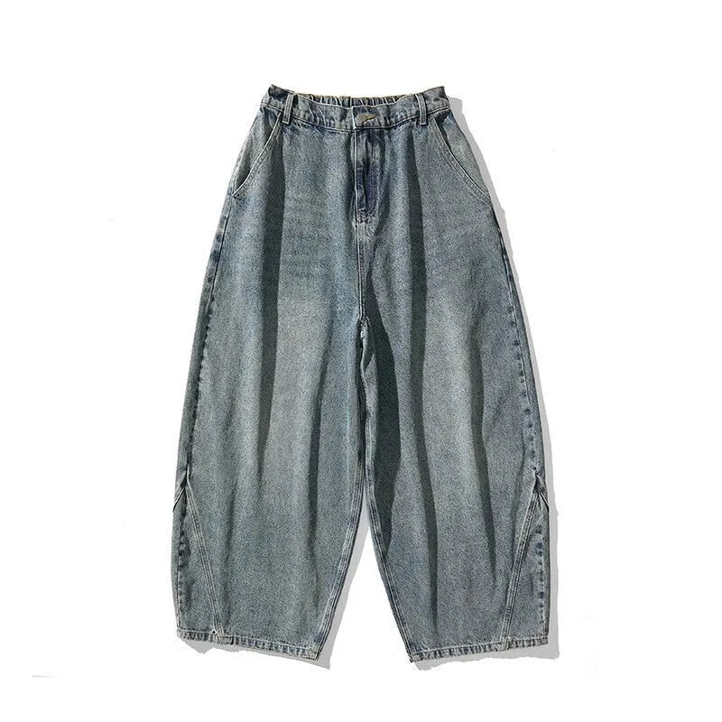 Men's plus-size light blue wide-leg denim jeans with a loose, baggy fit and straight legs on a hanger.