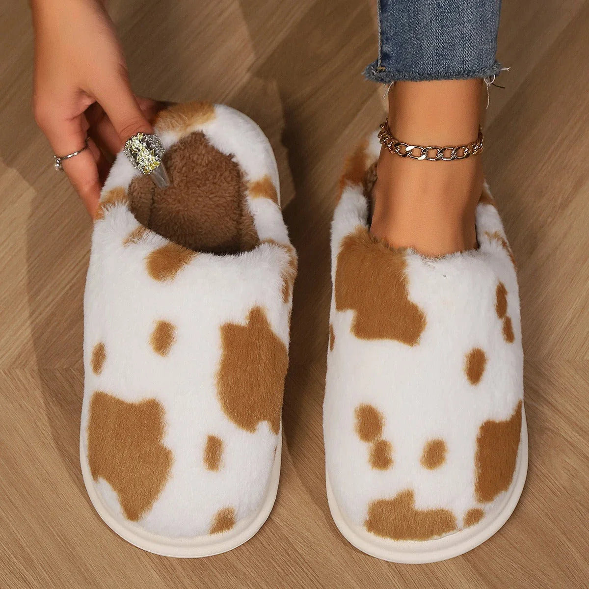 A pair of cozy, plush slippers with a unique spotted pattern, designed for warm and comfortable indoor wear.