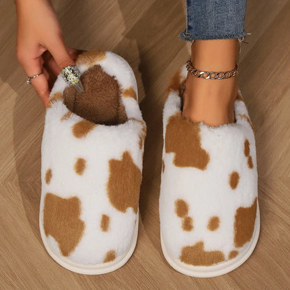 A pair of cozy, plush slippers with a unique spotted pattern, designed for warm and comfortable indoor wear.