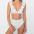 Women's black and white polka dot bikini set with deep V-neck and ruffled detailing