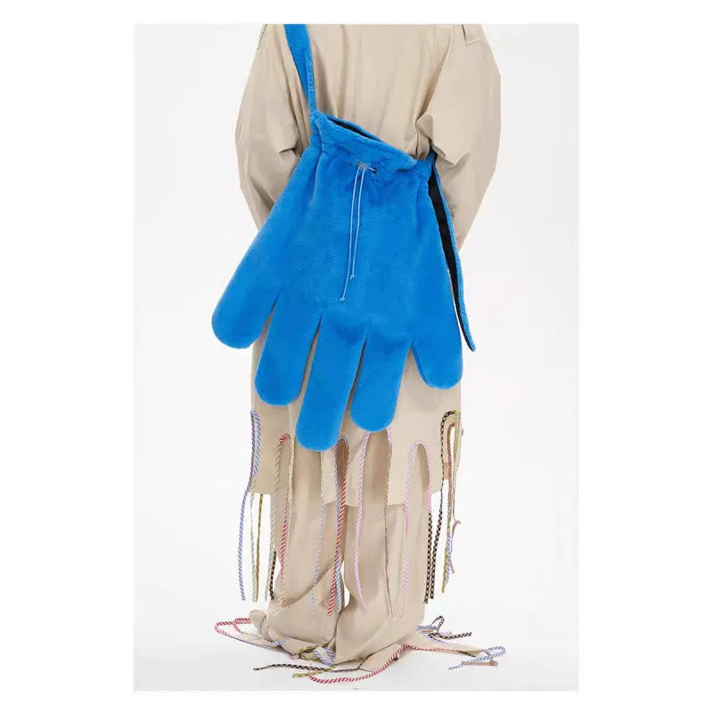 Blue fur 14-inch crossbody bag with velvet lining and sewing thread details, shown on a model for scale