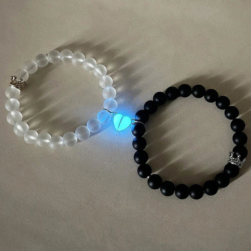 Luminous glow-in-the-dark crown bracelet set in white and black colors, showcasing a unique design and enchanting nighttime glow