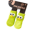 Dog all-season universal cotton socks with cute big eyes, anti-slip sole, green colour, side view on wooden floor