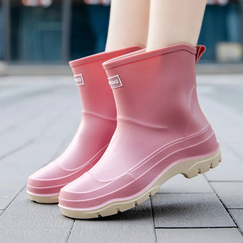 Women's short waterproof rubber shoe with non-slip sole in white colour on a flat heel.