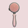 Green two-sided pet grooming brush showing slicker brush and silicone massager sides with anti-slip handle