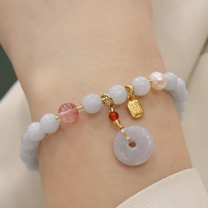 Gold plated women's bracelet with aquamarine chalcedony crystal pendant and floral design.