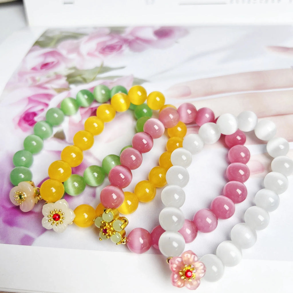 Handmade glass beaded bracelet with floral design in yellow, pink, white, or green colour options.