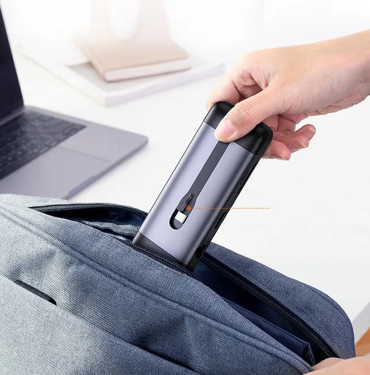 A compact USB-C hub adapter with short cable, showing HDMI, USB 3.0, Power Delivery, and other ports.