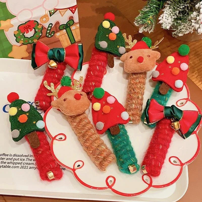 Festive Christmas hair ties for girls in various holiday-themed designs, including red bells, green trees, and khaki deer.