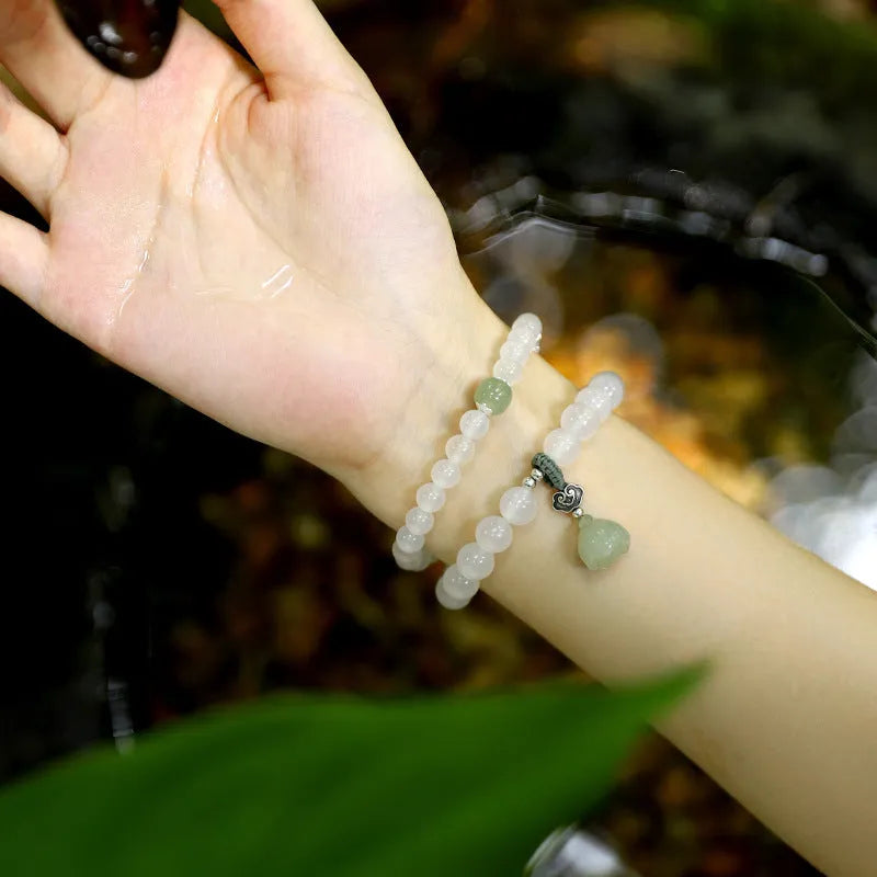 S925 silver bracelet with white agate and Hetian jade stones forming a geometric lotus design.