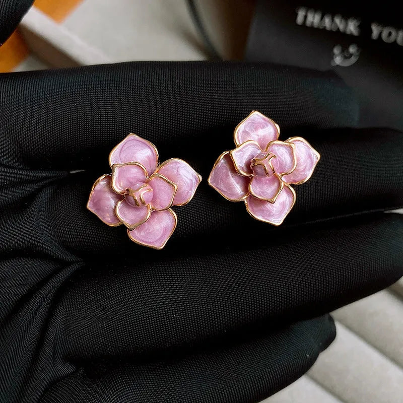Gold-plated purple oil-spot glaze floral stud earrings on a copper base.