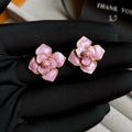 Gold-plated purple oil-spot glaze floral stud earrings on a copper base.