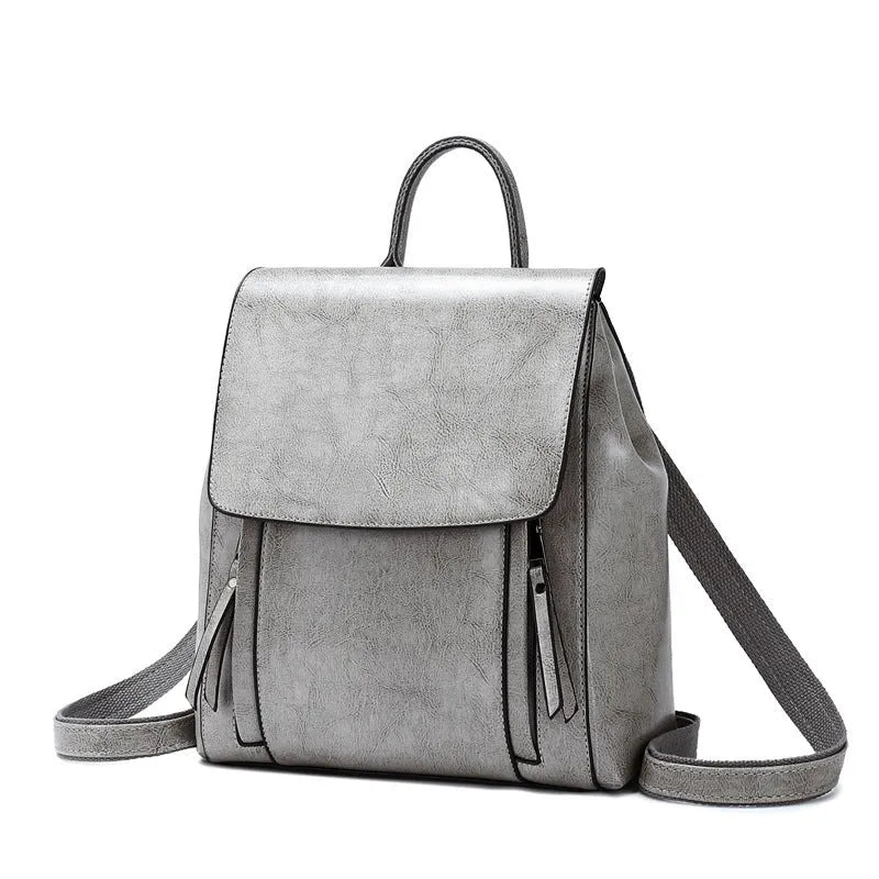 Large square black leather women's backpack with stitching and dual straps.