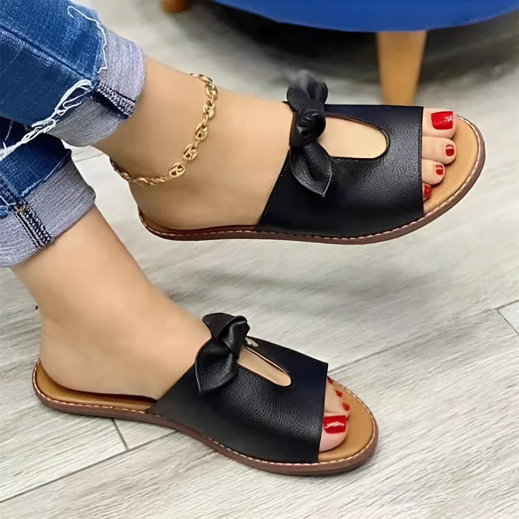 Ladies casual sandals with fish mouth design and a bow on the upper, in black, pink, or gold.