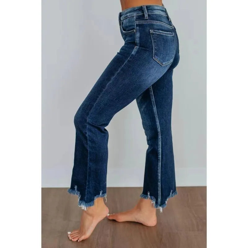 Women's solid colour denim jeans with a hand-worn distressed finish in dark blue.