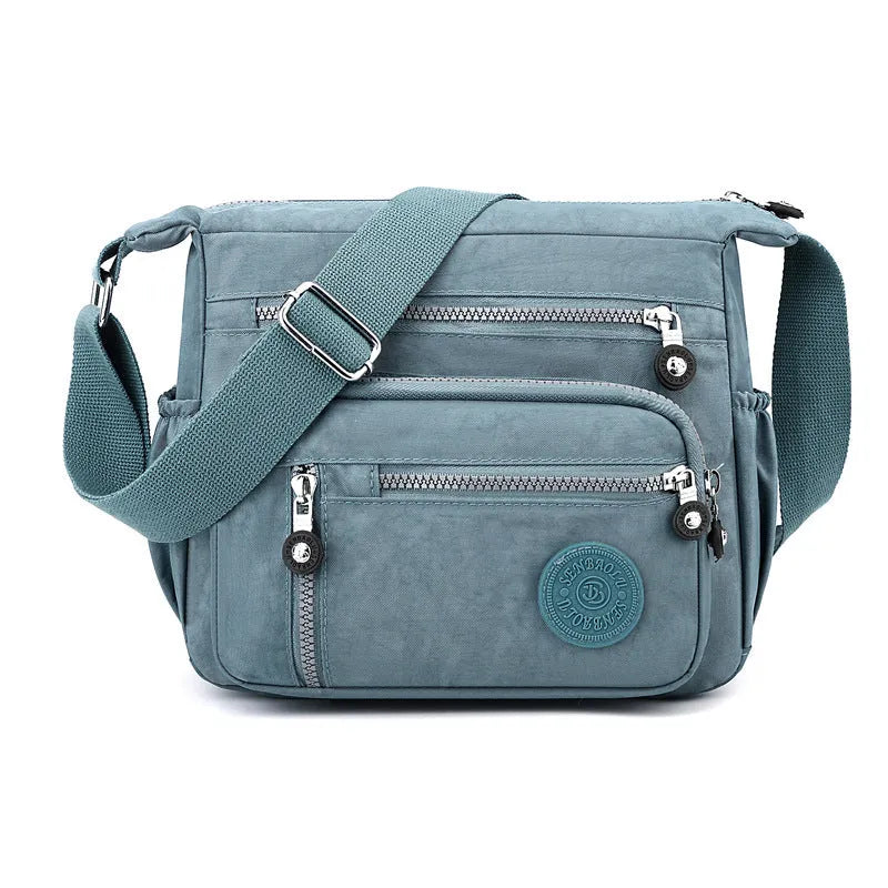 Lightweight grey nylon shoulder messenger bag with a single strap, shown in a square vertical shape.