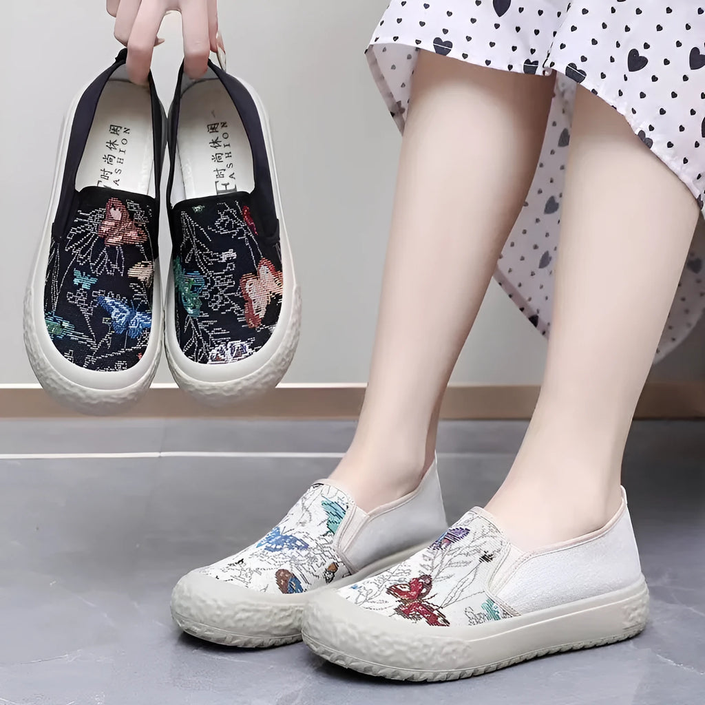 Women's canvas slip-on shoes with plastic soles in black and white colours showing sewing thread decoration