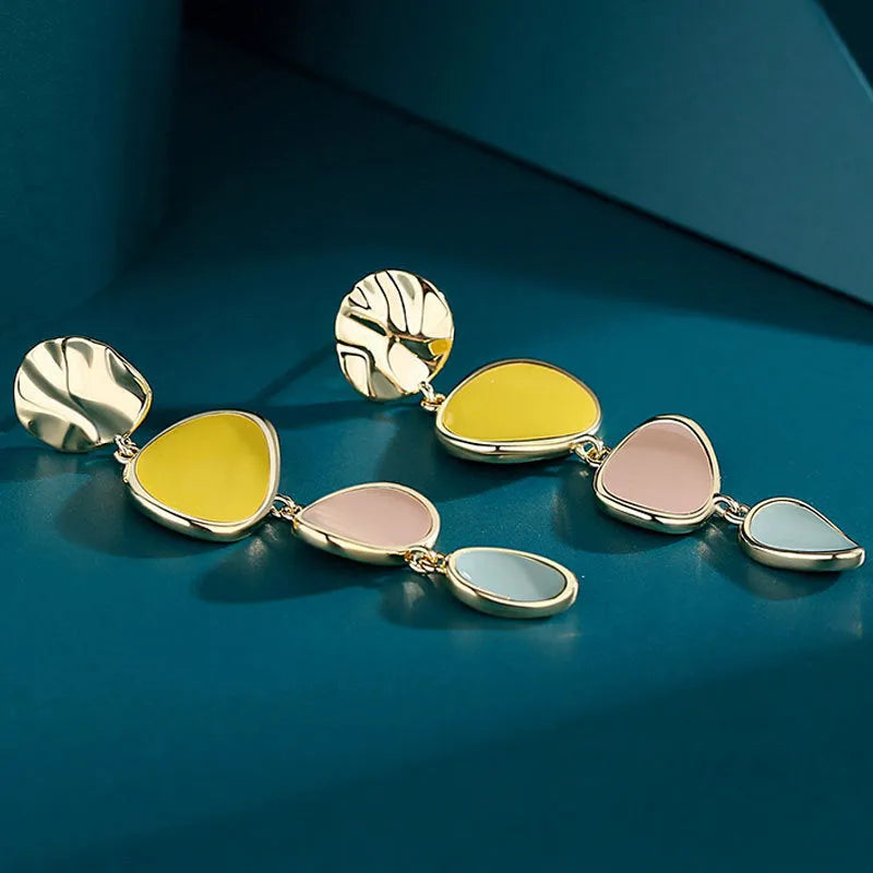 A pair of simple disc-shaped alloy earrings with a Morandi colour oil-drip finish on a sterling silver post.