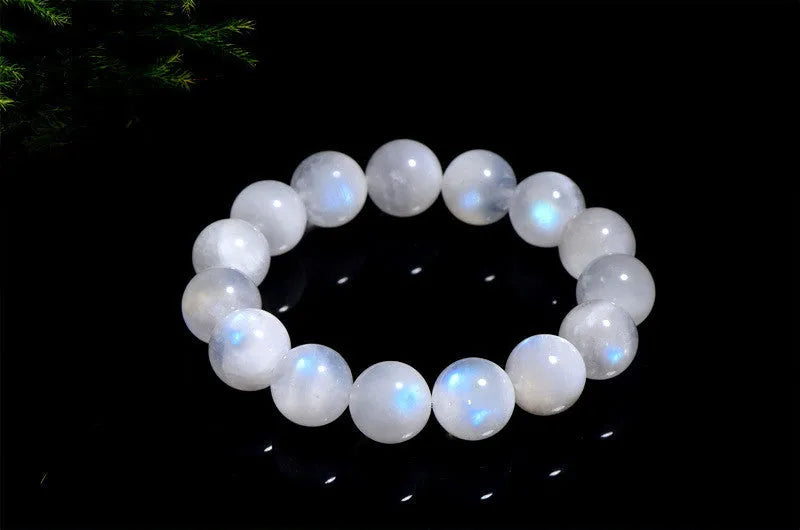 Natural blue moonlight round bead moonstone bracelet in white, showing polished stone surface.