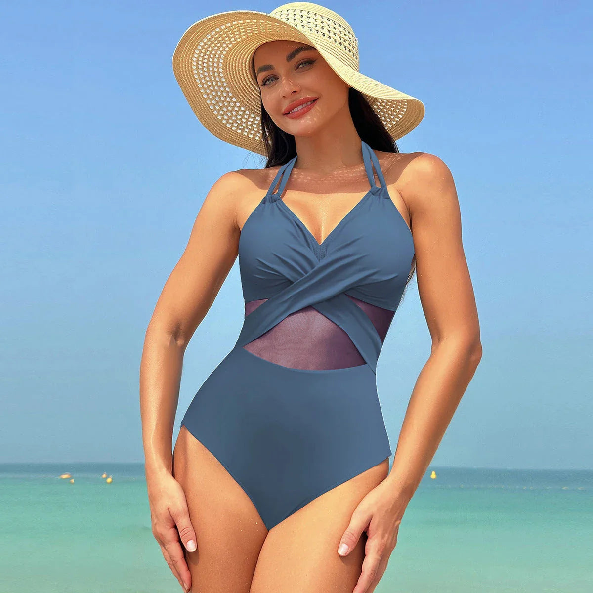 Stylish one-piece swimsuit with cross-strap design and mesh panels, available in a variety of vibrant colors