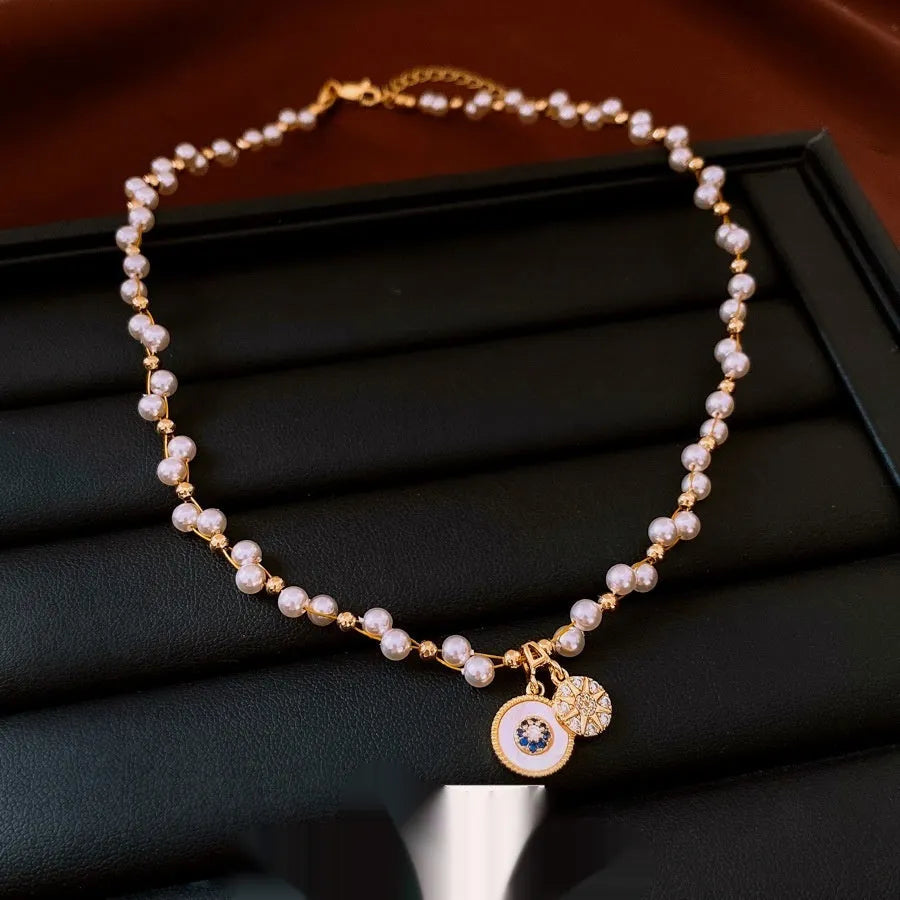 Gold electroplated necklace with white round pearl pendant on clavicle chain