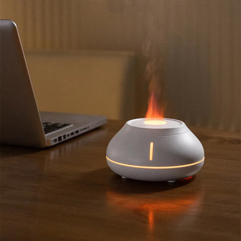 Round resin aroma diffuser with colourful flame effect lighting on desktop