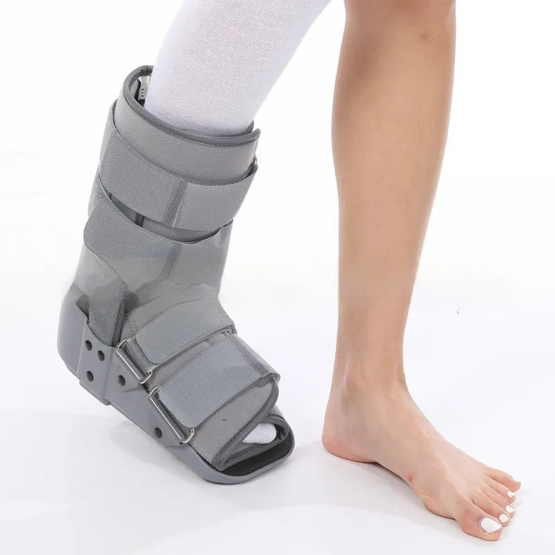 Grey and black adjustable Achilles tendon rehabilitation walking boot with plastic shell and straps.