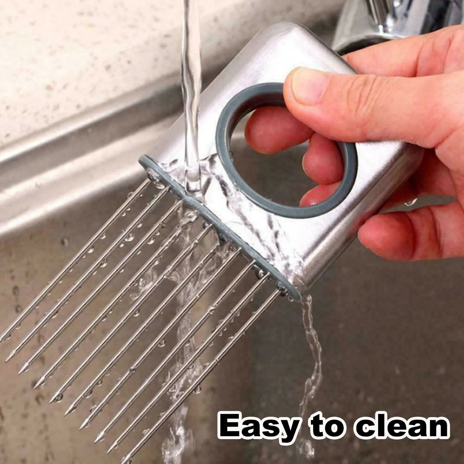 Stainless steel onion holder with sharp prongs and a finger guard on a kitchen counter.