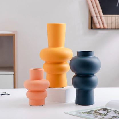 Nordic minimalist ceramic vase in blue, yellow, and orange with glazed finish