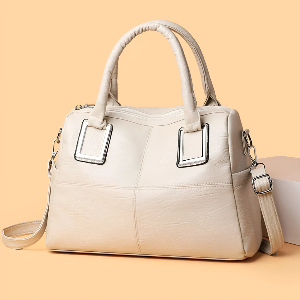 Simple large capacity women's shoulder bag in a neutral colour with internal phone and document pockets.