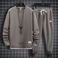 Men's wool-blend long sleeve tracksuit set in dark grey, front view, on model