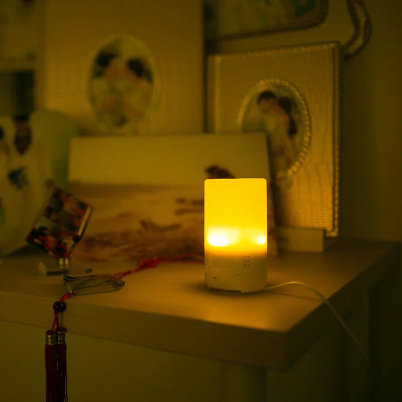 Essential oil aromatherapy machine with seven colour LED lights on a wooden table