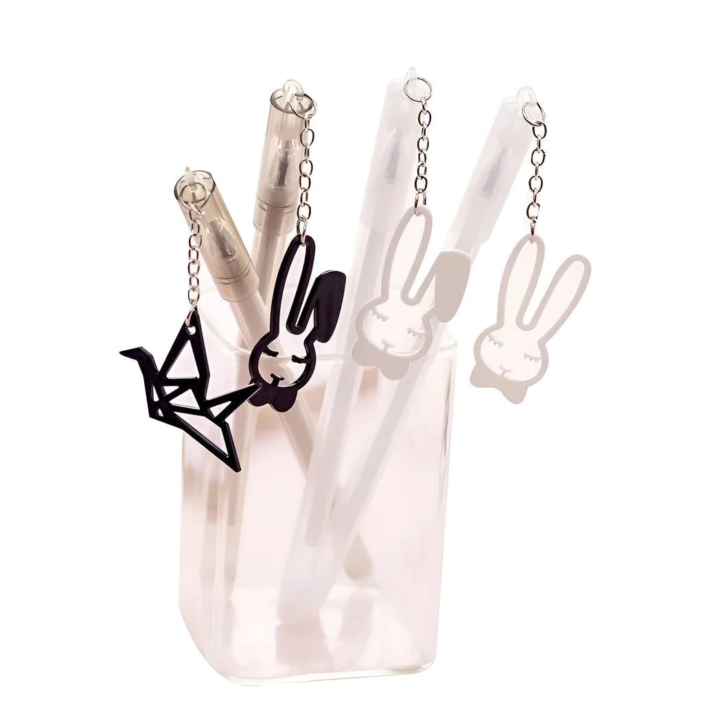 White and black gel pen with removable paper crane and rabbit pendant charms on a 17cm plastic body