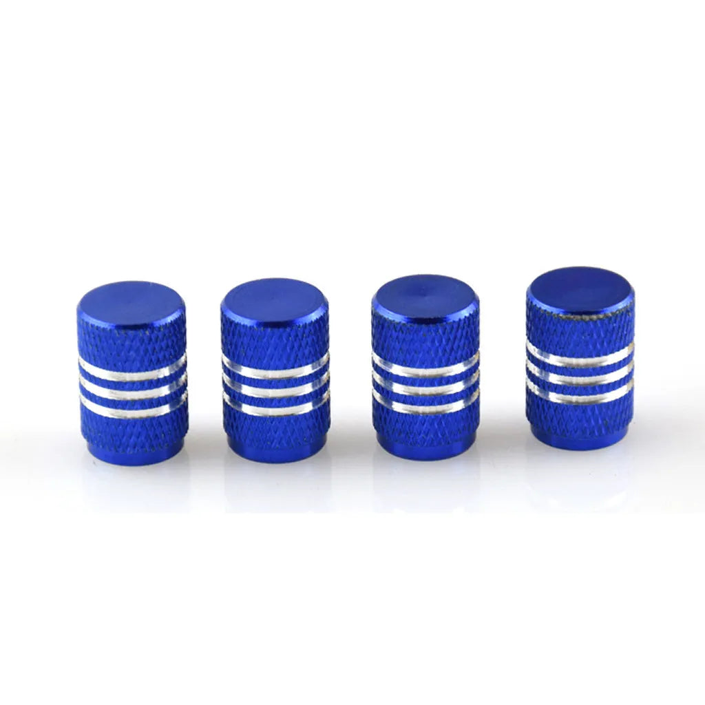 Set of coloured aluminium alloy car tyre valve caps in stainless steel on a grey background.