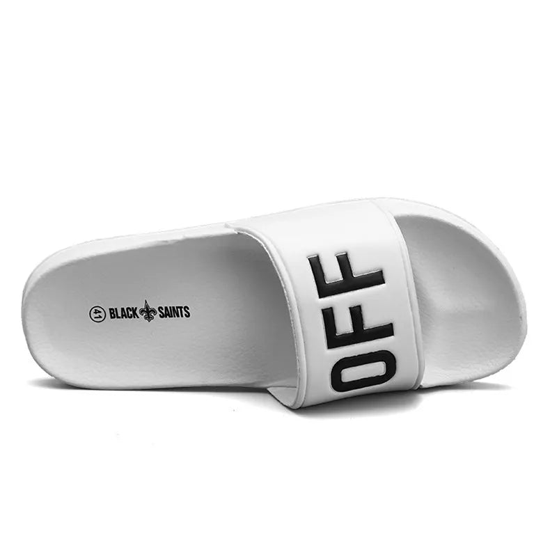 A pair of large men's open-toe slippers with a rubber sole, shown in black.